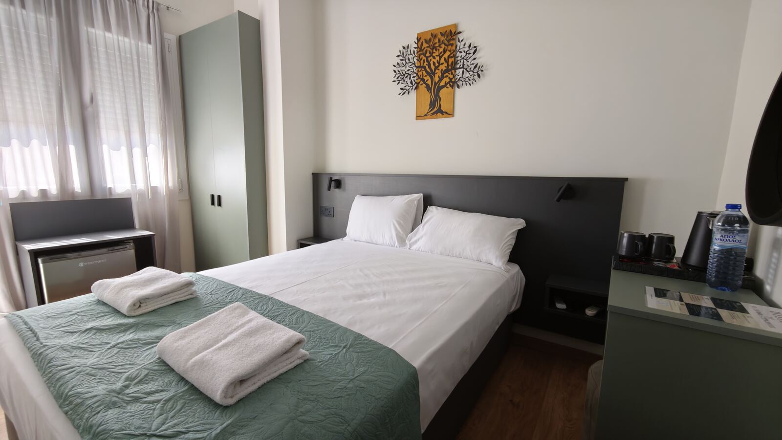 Room H5 bed with tree wall art and sage wardrobe, St. Lazarus City Hotel