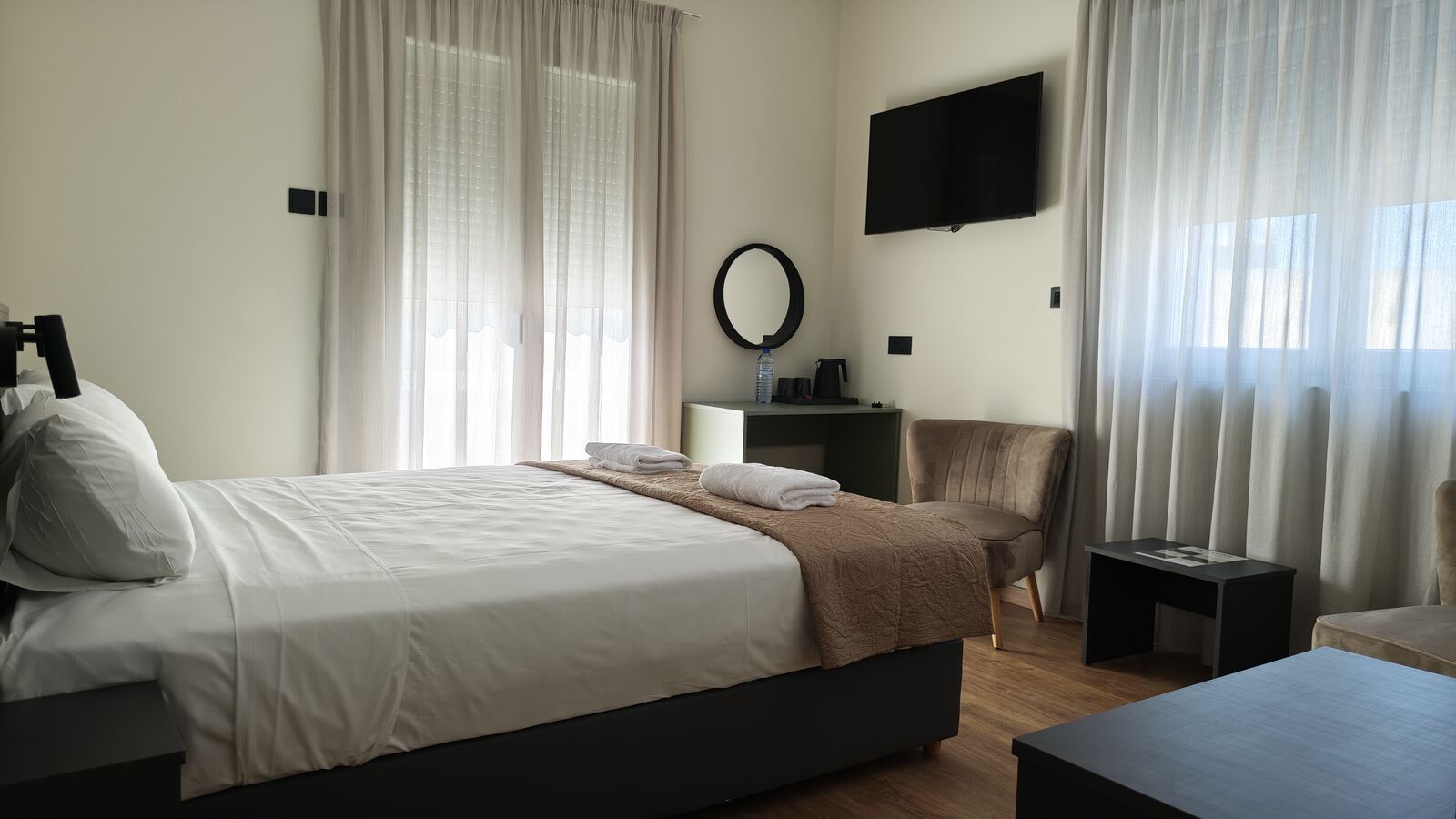 Room H6 full view with balcony doors and velvet armchair, St. Lazarus City Hotel