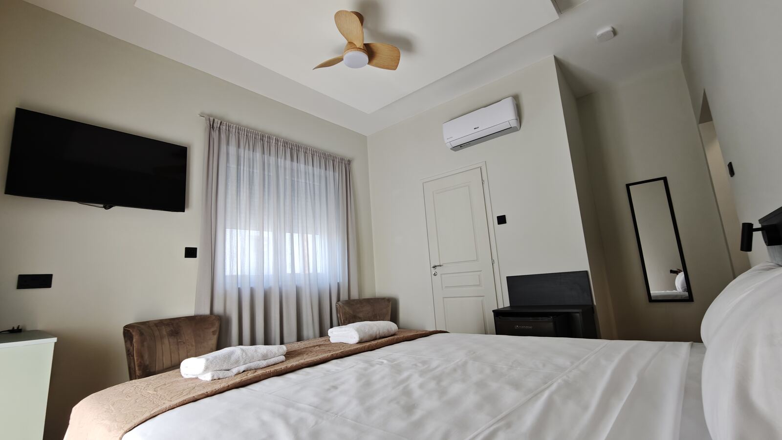 Room H6 with wooden ceiling fan and warm neutral tones, St. Lazarus City Hotel
