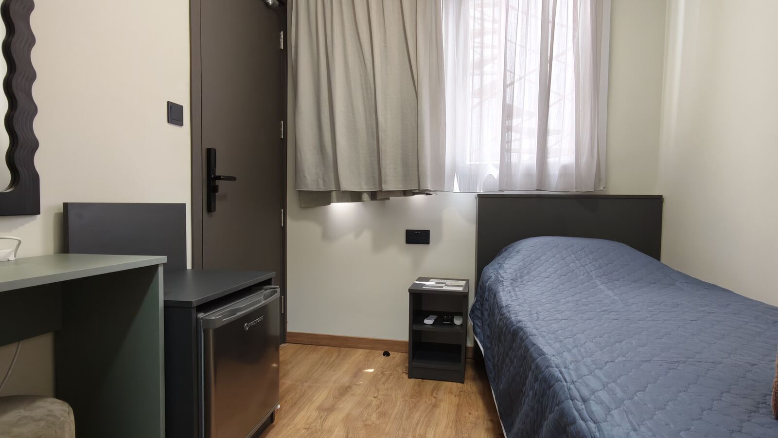 Room H8 alternate angle showing mini-fridge and desk, St. Lazarus City Hotel