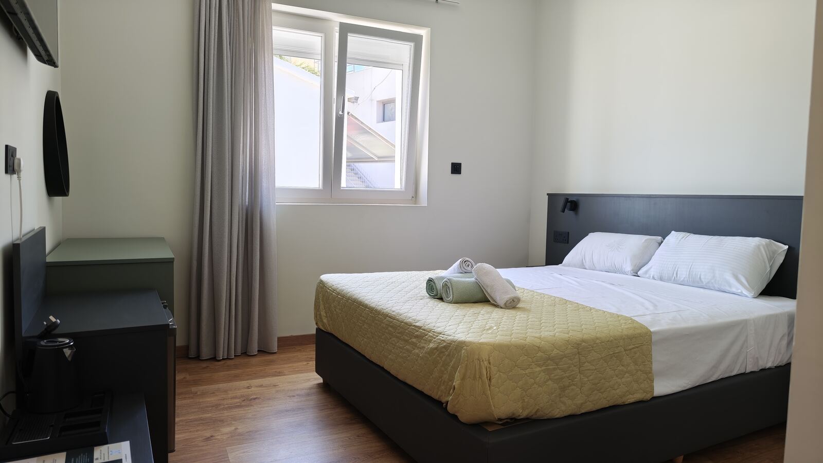 Standard double room with mustard bedspread, another instance of the shared design, St. Lazarus City Hotel