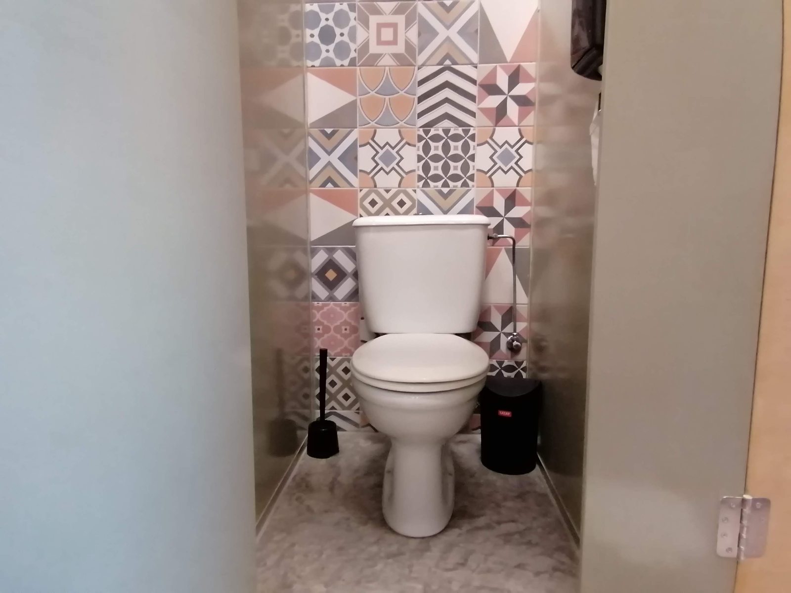 A patterned-tile shower stall at Le Mat Hostel