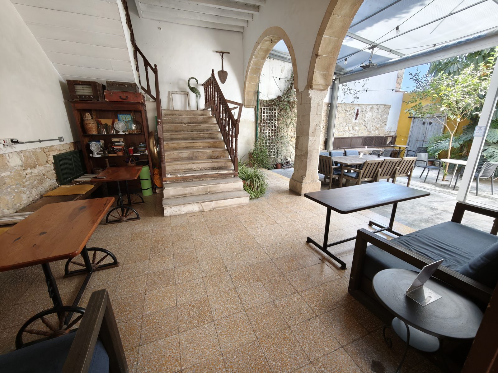 The common area and staircase at Le Mat Hostel, opening onto the courtyard