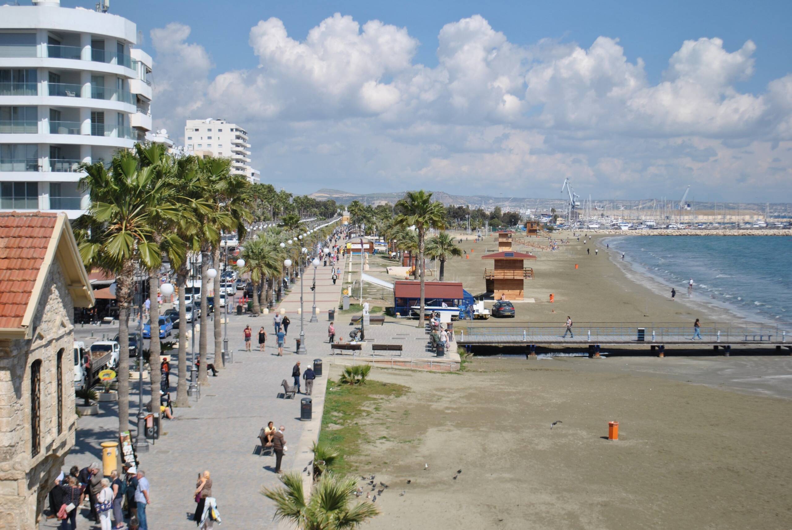 Finikoudes Beach promenade, Larnaca, palm trees and the marina in the distance
