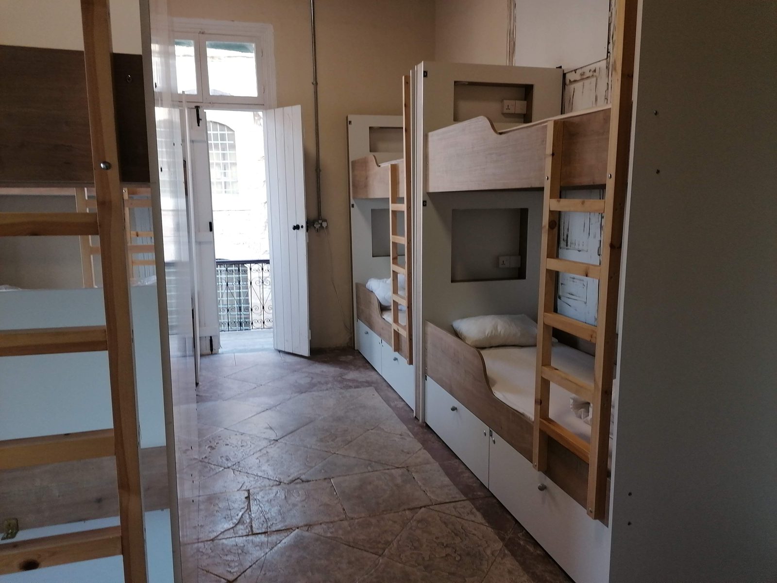 La Roue de Fortune dorm with bunk beds and balcony doors