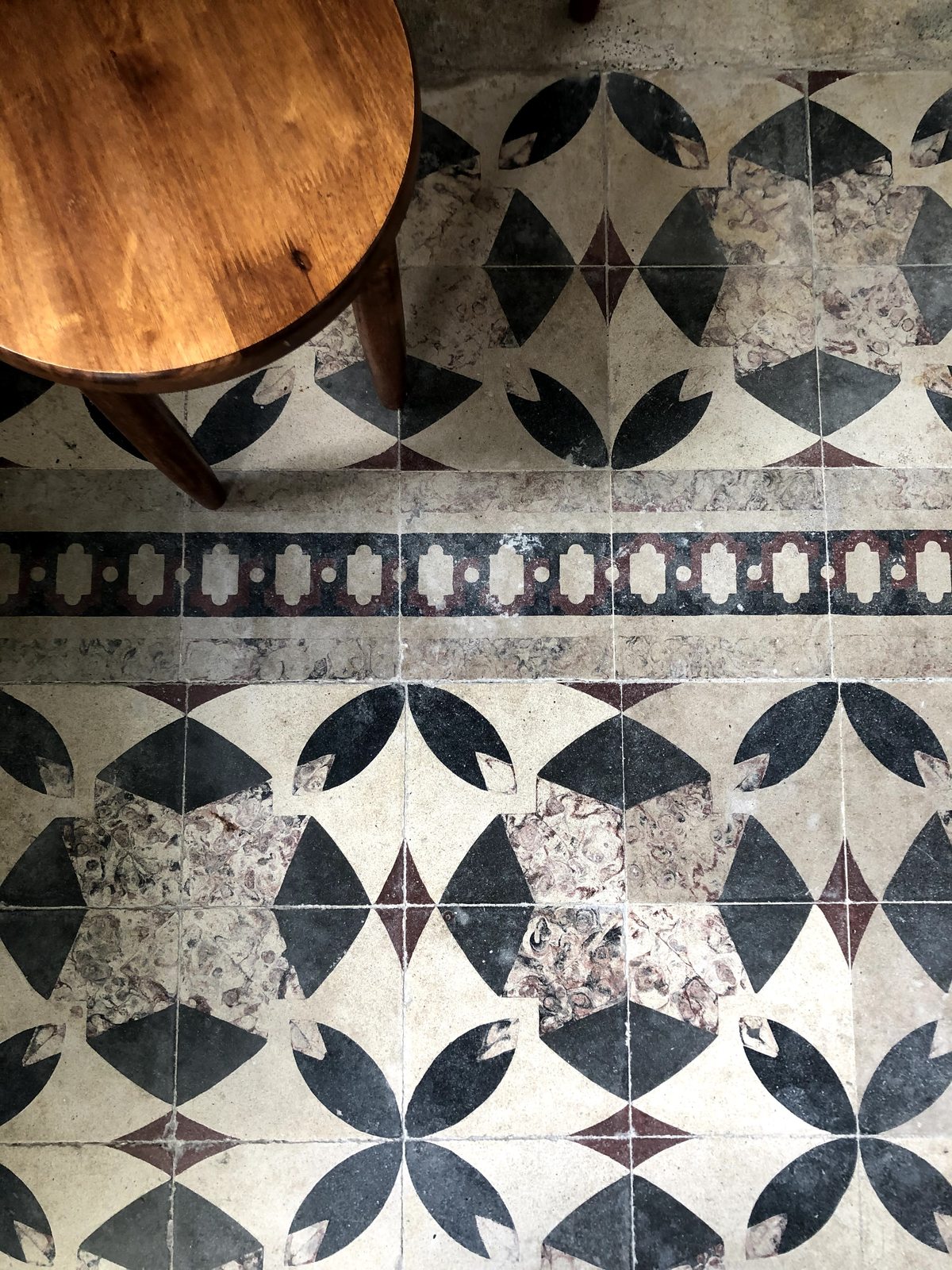 Detail of the original patterned tile floor at Le Mat Hostel